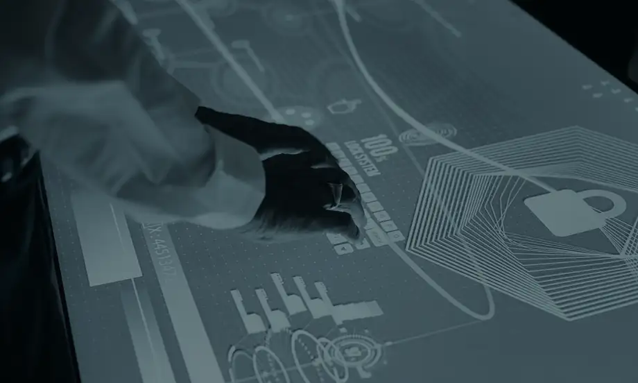 The use of an interactive table is demonstrated. A person is currently tapping on a keyboard that appears on the display of the digital table.